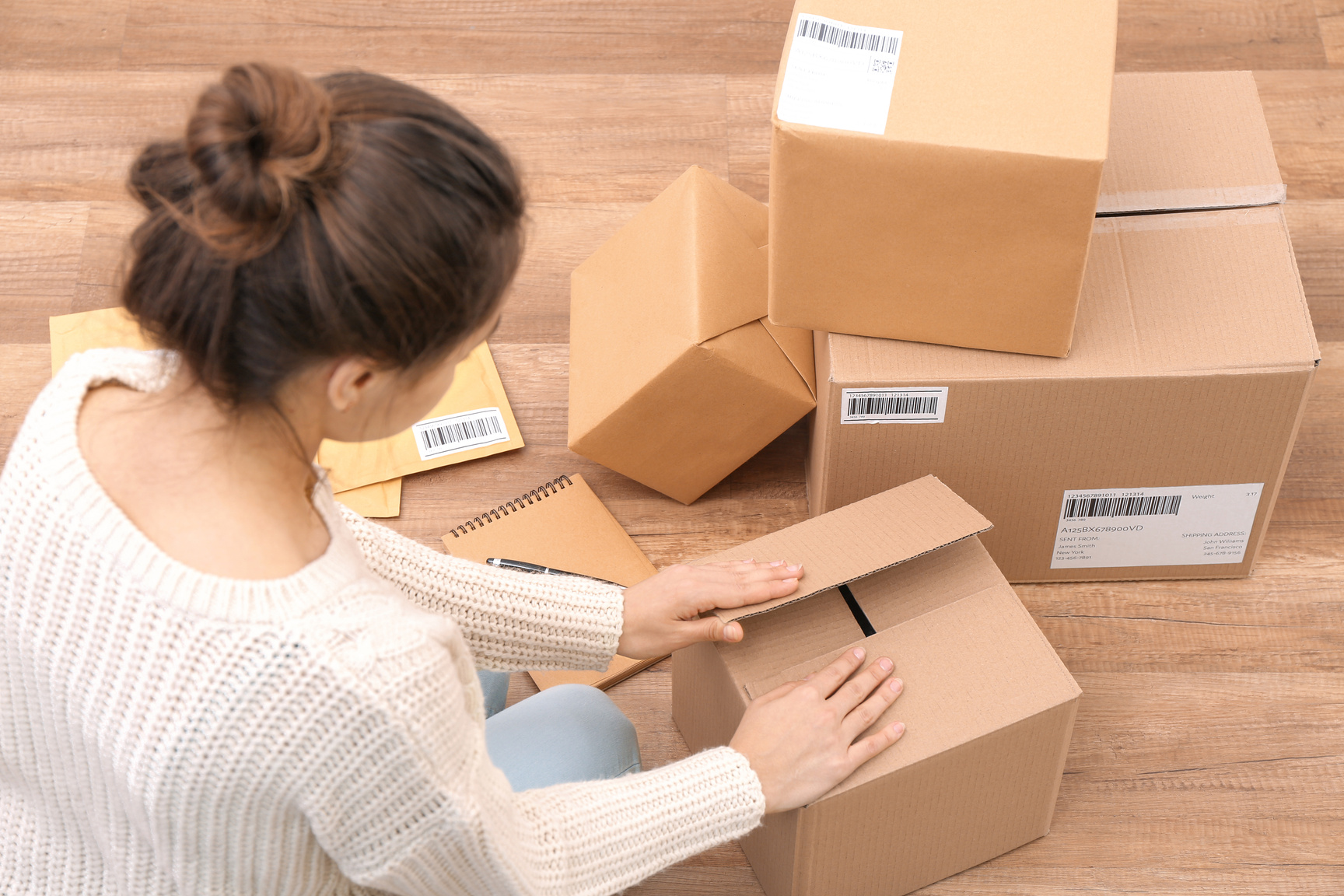 Woman Packing Her Products for Shipment Indoors